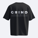 Black t-shirt with 'GRIND' printed on the back against a white background