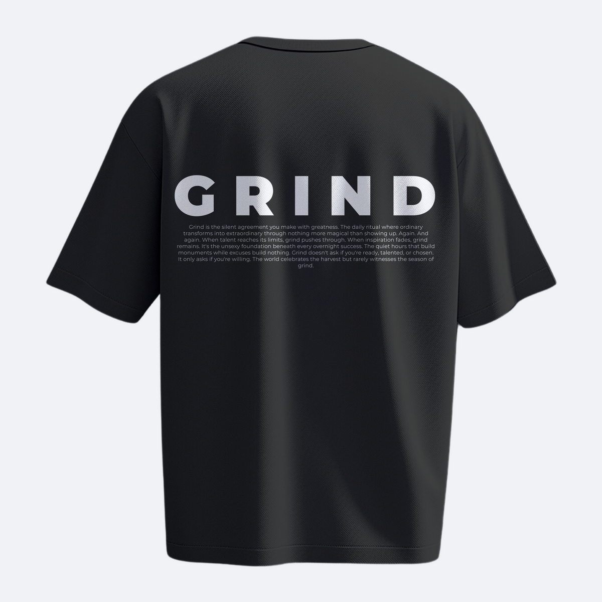 Black t-shirt with 'GRIND' printed on the back against a white background